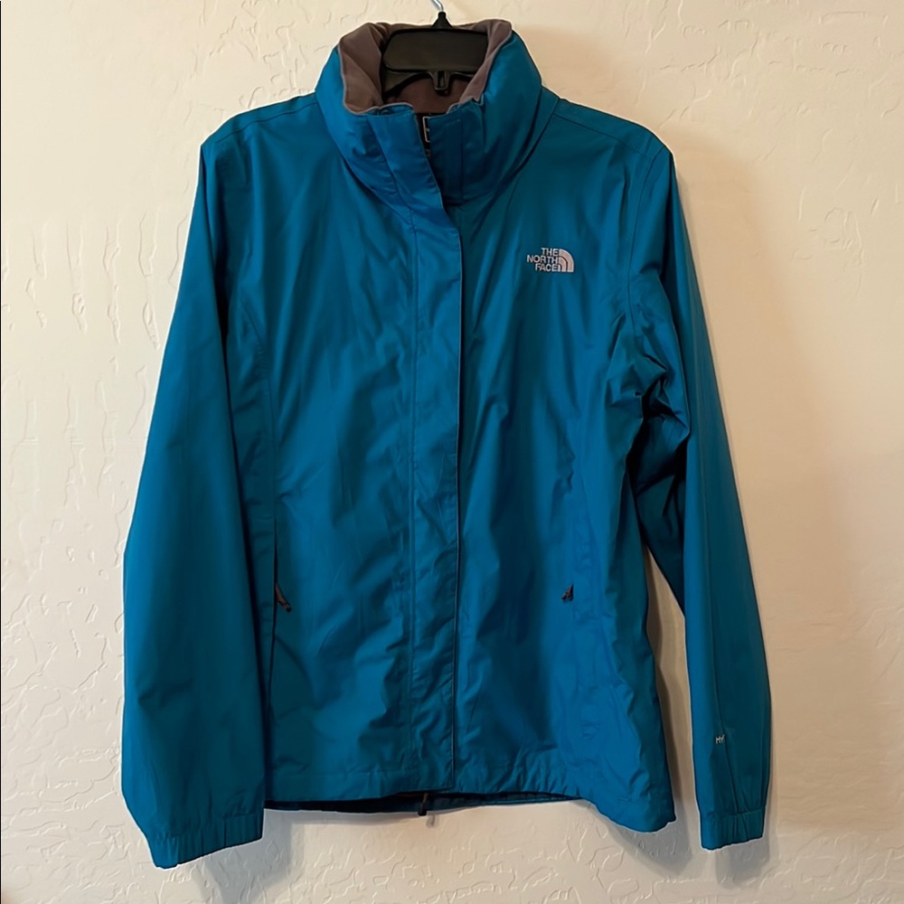 The North Face Women's Blue Rain Jacket. Sz Large. Rolled hidden hood.